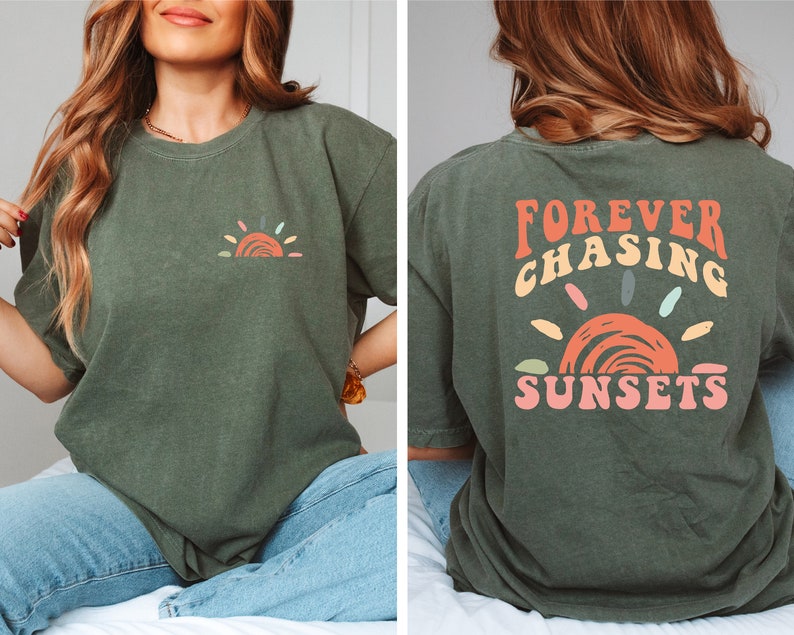 May include: A green t-shirt with a small, colourful sun graphic on the front and the text "FOREVER CHASING SUNSETS" in colourful letters on the back.