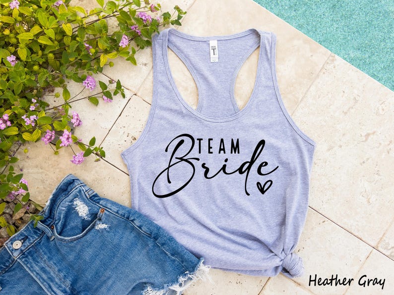 May include: A heather gray tank top with the text "Team Bride" in black script lettering and a small heart.