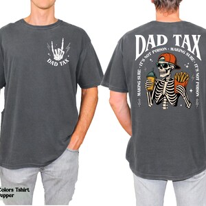 A man wearing a gray t-shirt with a graphic design on the back.