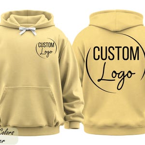 A yellow hoodie with the text "CUSTOM Logo" printed on the back.