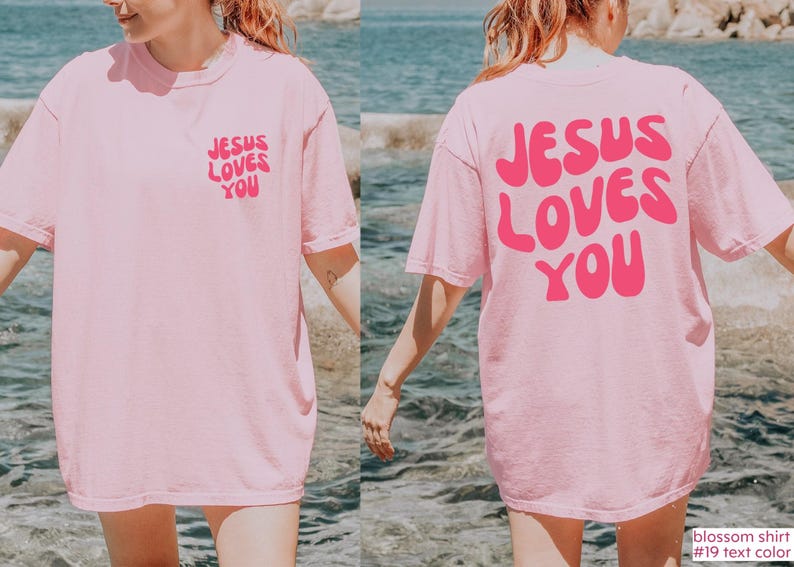 a woman in a pink jesus loves you t - shirt