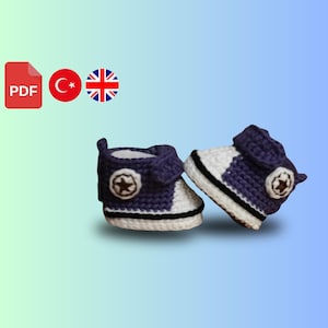 May include: A pair of purple and white crocheted baby booties with a star design. The booties are made with a soft yarn and have a comfortable fit.