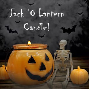 May include: A Jack 'O Lantern candle in a glass jar with a smiling jack-o'-lantern face. A small skeleton figurine sits next to the candle on a wooden surface.