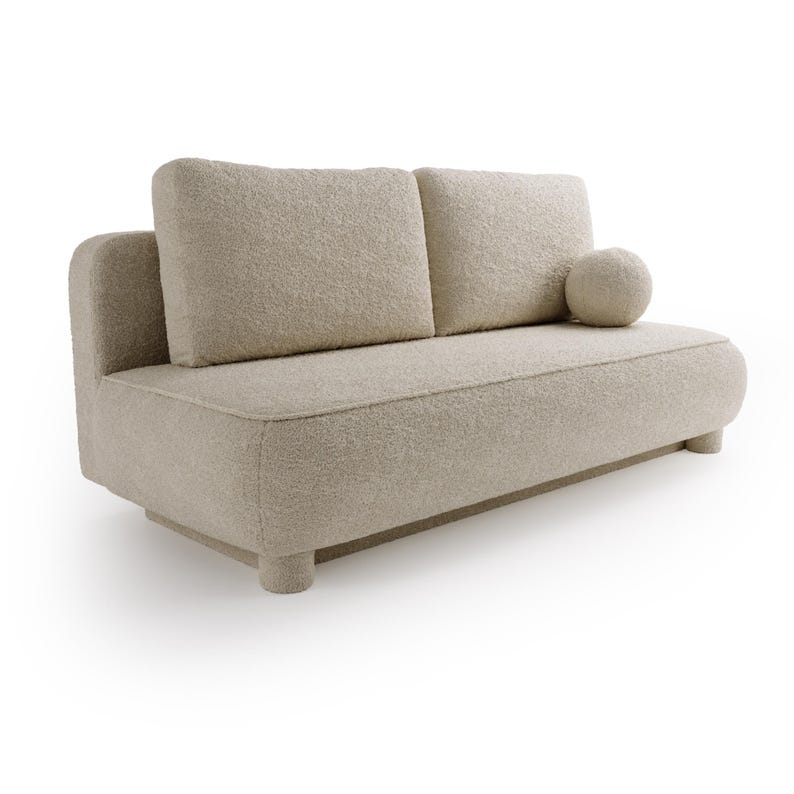 May include: A beige boucle fabric sofa with two square back cushions and a round bolster pillow. The sofa has a low profile with rounded armrests and sits on short, cylindrical legs. The overall design is modern and minimalist.