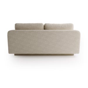 May include: A neutral-toned, modern sofa with a low profile and a textured, boucle fabric. The sofa features two back cushions and a wide, rectangular base. The overall design is minimalist and contemporary, suitable for various interior styles.