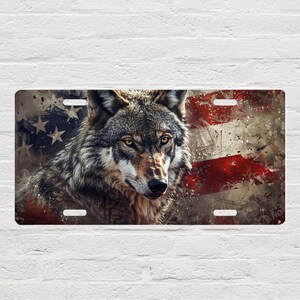 May include: A wolf with a fierce expression is shown against a distressed American flag background. The flag is red, white, and blue with a grunge effect.