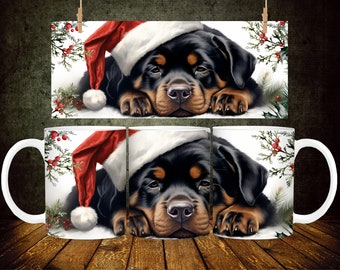 May include: A white ceramic mug with a black and brown Rottweiler puppy wearing a red Santa hat. The puppy is lying down with its head resting on its paws. The mug has a white handle and a white background with green holly and red berries.