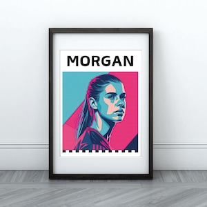 May include: A framed print of a woman's face in a colorful, abstract style. The woman has short, dark hair and is wearing a blue shirt. The print is titled "MORGAN".