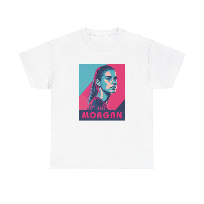 May include: White t-shirt with a graphic of a woman's face in a blue and pink color scheme. The text "MORGAN" is printed below the graphic.