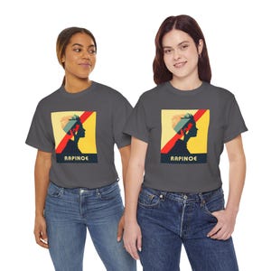 May include: Two people wearing charcoal gray t-shirts with a graphic of a woman's silhouette with the text "RAPINOE" printed below. The graphic is in a retro style with red, yellow, and blue colors.