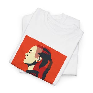 May include: A white t-shirt featuring a red background with a graphic of a woman's face in profile. The woman has a red and black hairstyle and is looking to the right.