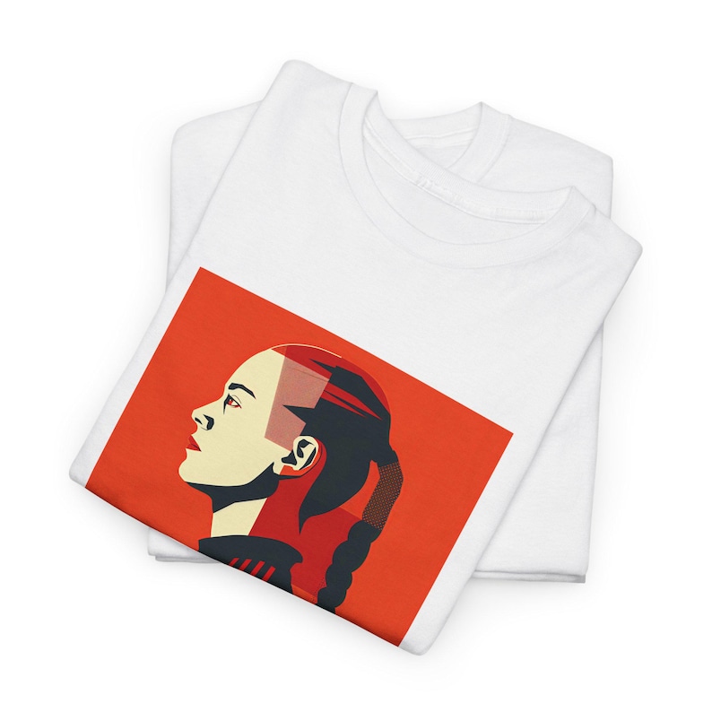 May include: A white t-shirt featuring a red background with a graphic of a woman's face in profile. The woman has a red and black hairstyle and is looking to the right.