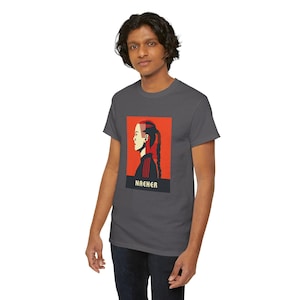 May include: A dark grey t-shirt with a red and white graphic of a woman's profile with the word "NACHER" printed below the graphic.