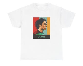 May include: White t-shirt with a retro-style graphic of a soccer player with the name "OCHOA" printed below. The graphic features a red, orange, and green color scheme.