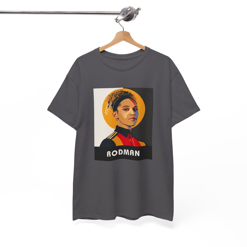 May include: A dark gray t-shirt with a graphic print of a person with a yellow halo and the word "RODMA