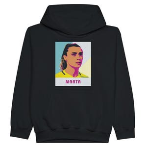 May include: Black hoodie featuring a colourful illustration of Marta, a renowned football player, on the front. The illustration is in a pop art style and includes the text "Marta" below the image.