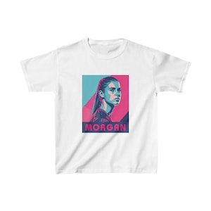 May include: White t-shirt with a graphic of a woman's face in a blue and pink color scheme. The text "Alex Morgan" is printed below the image.