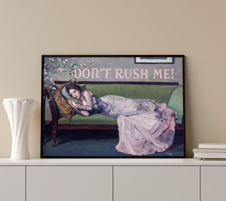 May include: A painting of a woman lying on a green velvet couch. She is wearing a pink and white dress and has her head resting on a pillow. The text "DON'T RUSH ME!" is written in pink letters above her head.