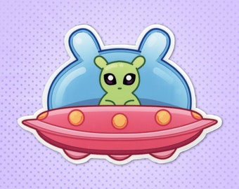 VINYL STICKER - Cute Green Alien in a UFO (Funny Animal / Creature / Monster / Critter Sticker for Space, Alien and Meme Enthusiasts)