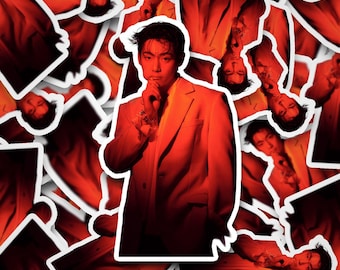 May include: A collection of stickers featuring a man in a light-colored suit, set against a vibrant red background. The man is depicted in a thoughtful pose, with his hand near his face. The stickers have a white border.
