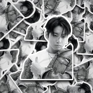 May include: Black and white sticker sheet featuring multiple images of a person in a white t-shirt and denim jacket. The person has tattoos on their arm and a lip piercing. The stickers are die-cut.