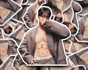 May include: A sticker sheet featuring multiple images of a person wearing a brown suit jacket and pants, with a Calvin Klein waistband visible. The person is also wearing a necklace.