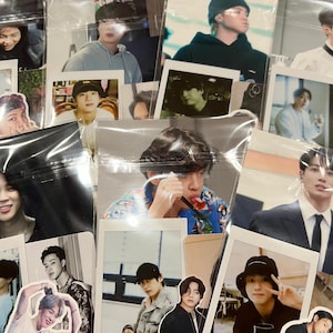 May include: A collection of various photographs and stickers featuring images of several people. The photographs are in different sizes and styles, some with white borders. The stickers are cut-out images of the people in the photographs.