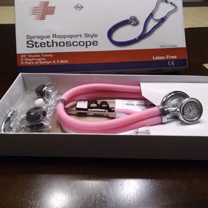 May include: A pink Sprague Rappaport style stethoscope with 22" double tubing, 2 diaphragms, and 2 pairs of eartips and 3 bells. The stethoscope is latex-free and comes in a white box with blue and orange accents.