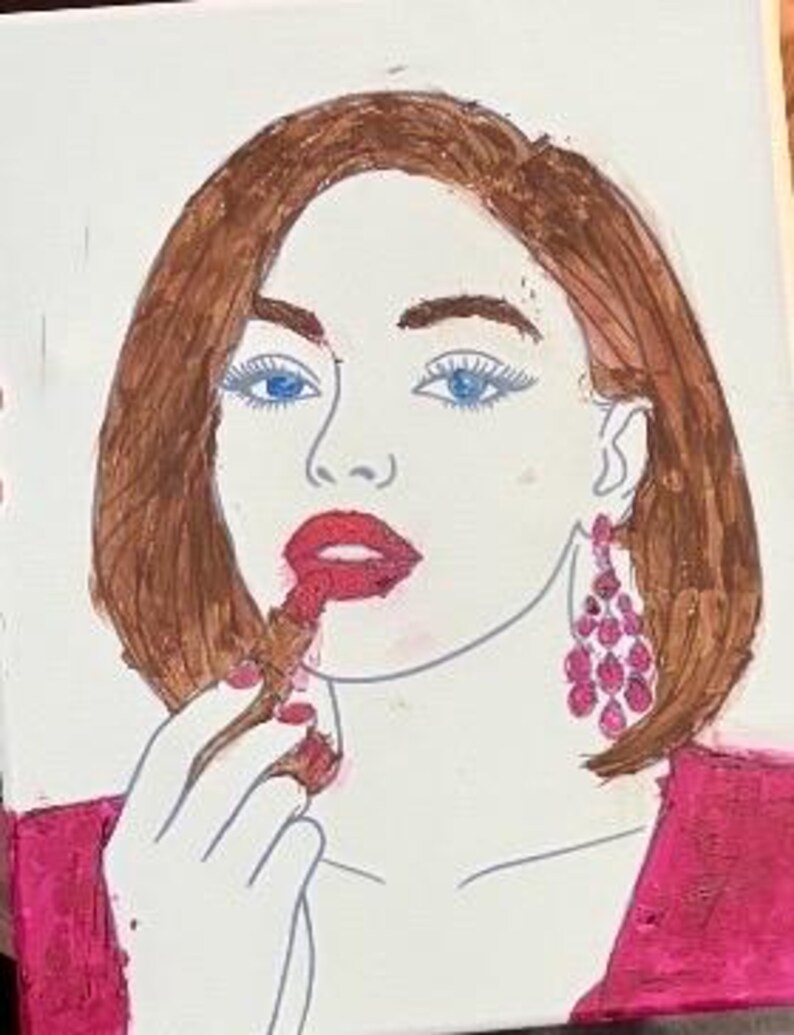 May include: A painting on canvas depicting a person with brown hair, blue eyes, and a pink top. The person is applying red lipstick and wearing large, dangling pink earrings. The artwork features bold outlines and vibrant colors on a light background.