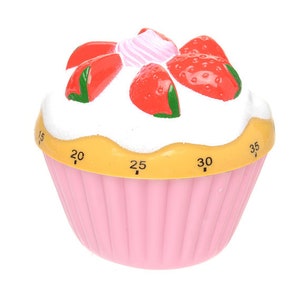 May include: Pink cupcake-shaped kitchen timer with a white frosting design and red strawberry accents. The timer has numbers 15, 20, 25, 30, and 35 printed on the side.