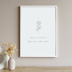 May include: A white framed print with a simple line drawing of a sprig of leaves and the text "HOLY SPIRIT You are welcome here".