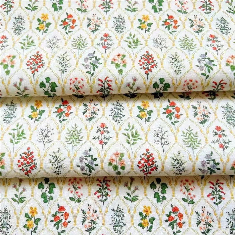 May include: White fabric with a repeating pattern of yellow, green, red, and pink flowers in a trellis design.
