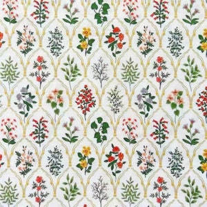 May include: A white fabric with a repeating pattern of various flowers and leaves in shades of red, yellow, green, and blue. The flowers and leaves are arranged in a grid pattern within gold arches.