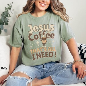 May include: A green t-shirt with the text "Jesus & Coffee That's All I Need!" and a cartoon image of a coffee cup with a cross and stars.
