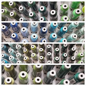 May include: A wall of spools of thread in various shades of blue, green, and teal. The spools are arranged in rows on a white background.