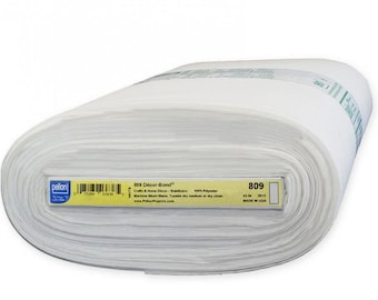 May include: A rolled bolt of white fabric labeled "809 Décor-Bond" with a yellow label. The label indicates the fabric is 45 inches wide and made of 100% polyester. The fabric is for crafts and home decor.