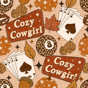 May include: A repeating pattern featuring pumpkins, playing cards, dice, and an 8-ball with a leopard print design. The text "Cozy Cowgirl" is displayed on a brown rectangular sign with a cream-colored border.