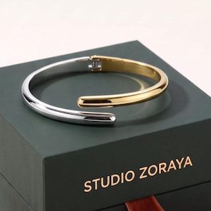 Pulsera tipo brazalete con diseño de bypass dorado, brazalete minimalista moderno apilable, brazalete de acero inoxidable chapado en oro que no se deslustra, regalo de joyería único y llamativo.