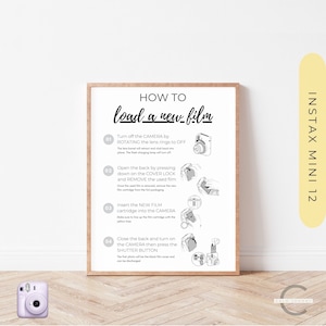 May include: A white framed poster with black text and illustrations showing how to load a new film into an Instax Mini 12 camera. The poster has the title "How to load a new film" and four numbered steps with illustrations of the camera.