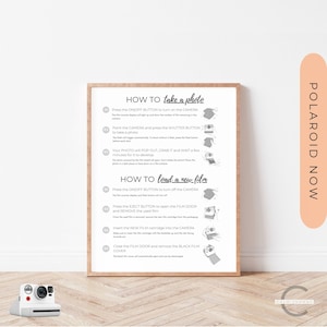 Peut inclure: Une affiche encadrée blanche avec du texte noir et des illustrations montrant comment prendre une photo et charger un nouveau film dans un appareil photo Polaroid Now. L'affiche comporte le texte "HOW TO take a photo" et "HOW TO load a new film" avec des illustrations de l'appareil photo et de ses fonctionnalités.