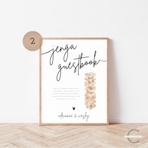 Puede incluir: Un cartel blanco con texto negro que dice "jenga guestbook". El cartel presenta un gráfico de una torre de jenga apilada. Debajo de la torre está el texto "Help us create beautiful memories one block at a time. Please sign a jenga piece with your wishes for the newly Mr. & Mrs." y los nombres "adrianne & wesley".