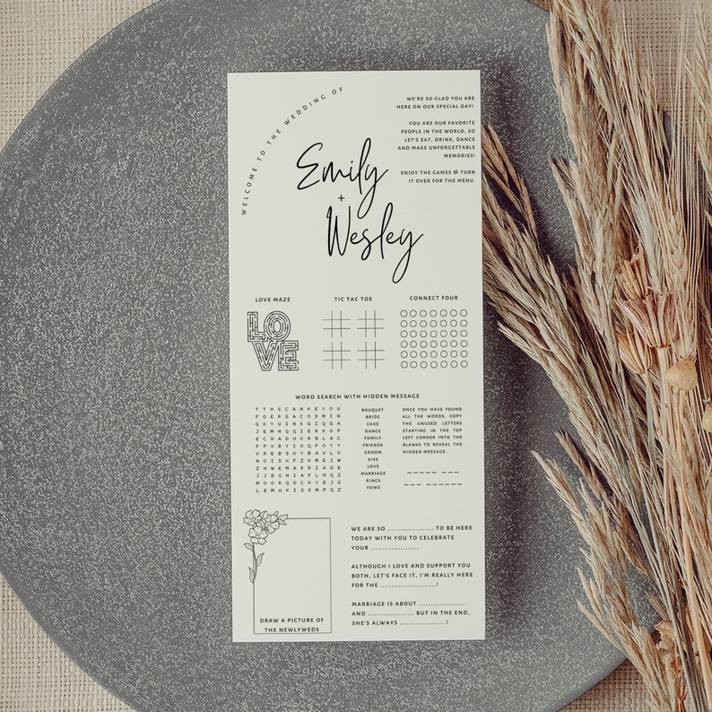 May include: A printable wedding reception game card with a black and white design. The card features a word search, connect four, noughts and crosses, and a love maze. The card also includes the text "Welcome to the Wedding of Emily + Wesley".