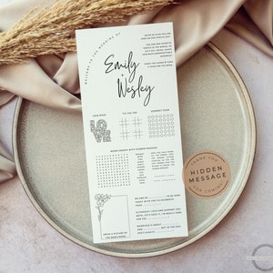 May include: A printable wedding reception game card with a white background and black text. The card features games such as a love maze, noughts and crosses, connect four, and a word search. The card also includes a thank you message for coming and a space to draw a picture of the newlyweds.