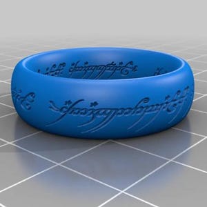 May include: A blue plastic ring with the inscription "One Ring to rule them all, One Ring to find them, One Ring to bring them all and in the darkness bind them" in an elvish script.