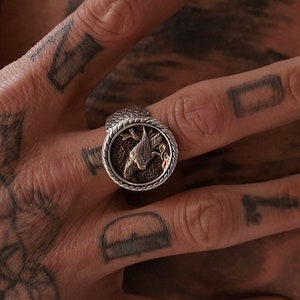 An elegant yet fierce raven ring forged in solid silver with symbolic Norse engravings, designed for lovers of Viking culture and mystical artifacts. This piece serves as a wearable talisman of intuition and strength, ideal for birthdays, anniversaries, or custom engraved gifts.