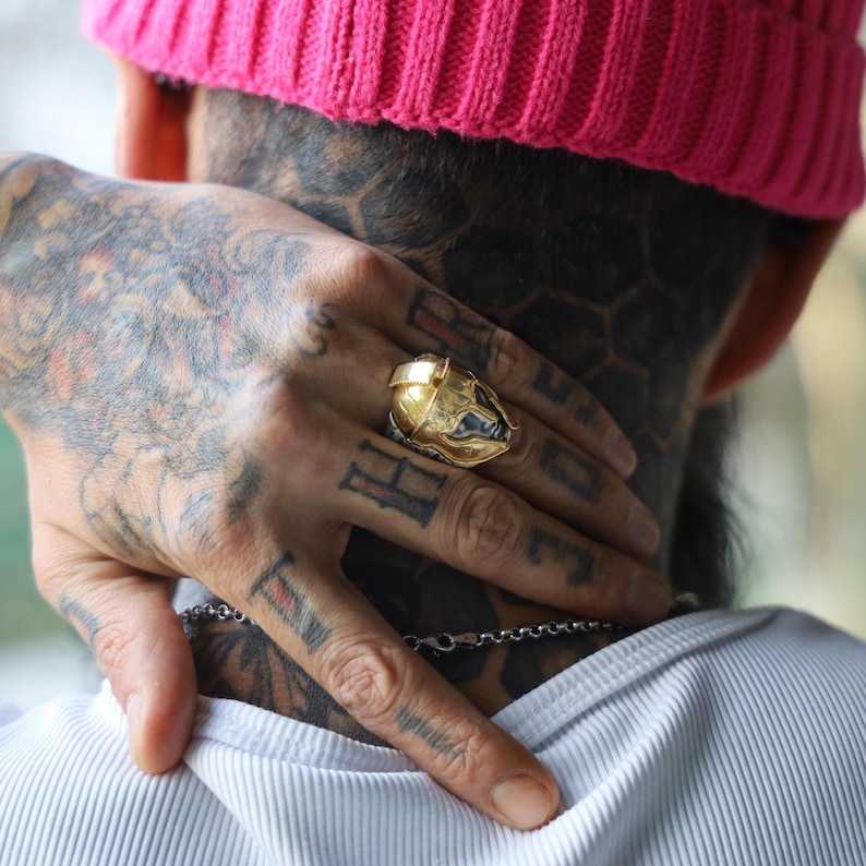 Set against a minimalist white background, this 14K gold plated Spartan warrior ring for men showcases its bold design and rugged elegance. With a 26.21mm diameter and 4mm thick band, this Greek mythology ring is a true symbol of inner strength and historical beauty, perfect for men who appreciate meaningful jewelry with a warrior edge.