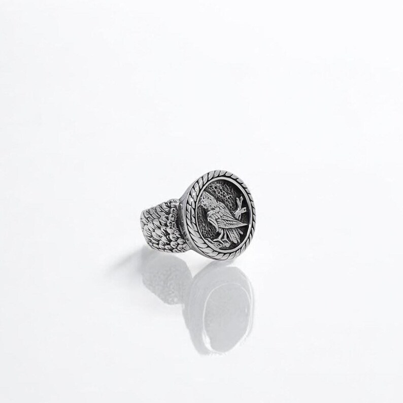 A handcrafted Norse raven ring made of high-quality silver, showcasing an intricately engraved raven motif inspired by Viking mythology. This powerful piece symbolizes wisdom, transformation, and divine protection, making it a meaningful gift for men who resonate with ancient legends and warrior spirit.