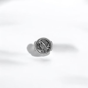 A mystic Viking raven ring made from sterling silver and carefully oxidized to highlight the deep engravings, this ring captures the essence of Norse tradition and divine insight. A standout piece for any man seeking to express power, mystery, and personal meaning through jewelry.