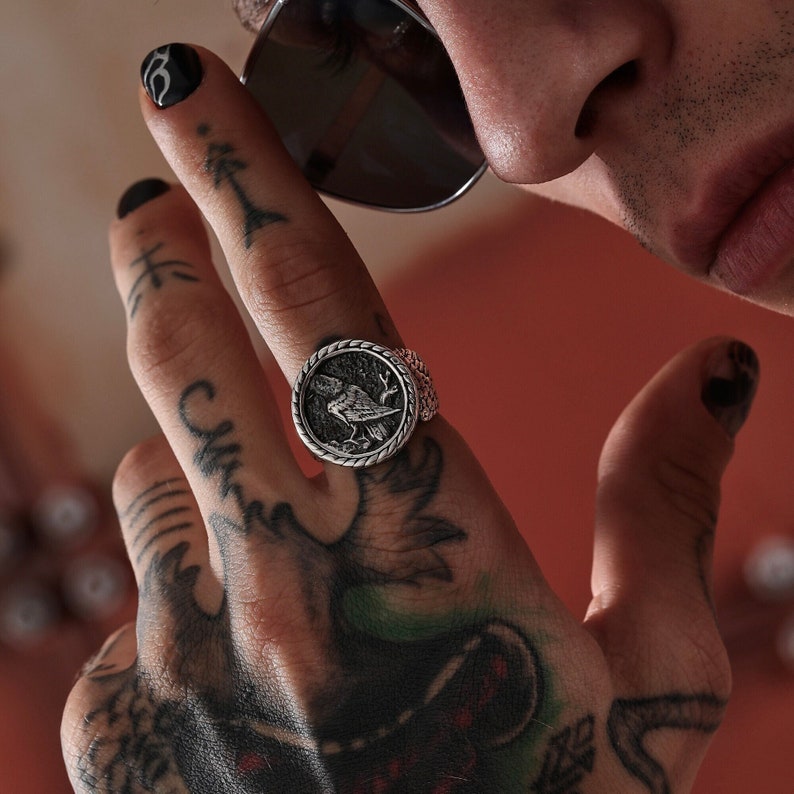 An artisan silver Viking ring featuring a detailed raven design rooted in Norse mythology, representing knowledge and connection to the gods. This bold statement ring is crafted for modern-day warriors who value symbolism, heritage, and exceptional craftsmanship.