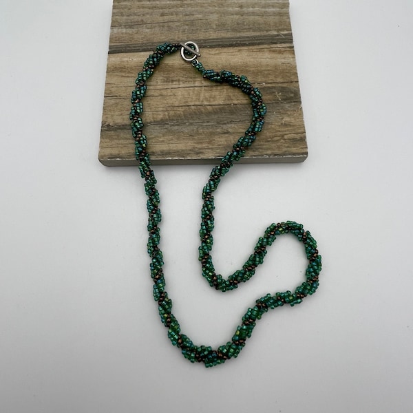 Short twisted seed bead vintage necklace in green and bronze with silver tone toggle clasp